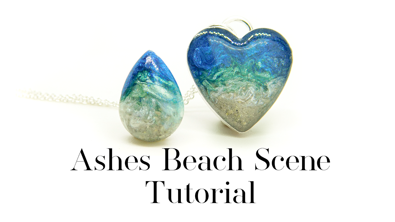 Ashes Beach Scene necklace, Tutorial necklace, ashes heart in artistic ash as sand. 14x10mm teardrop pocket stone and 16mm heart bezel necklace setting. UV and epoxy resin jewelry for filling, memorial jewellery making in solid sterling silver 925, free tutorial from Nikki Lovegrove